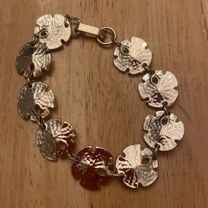 Gold tone sand dollar bracelet about 7 inches. Light gold tone